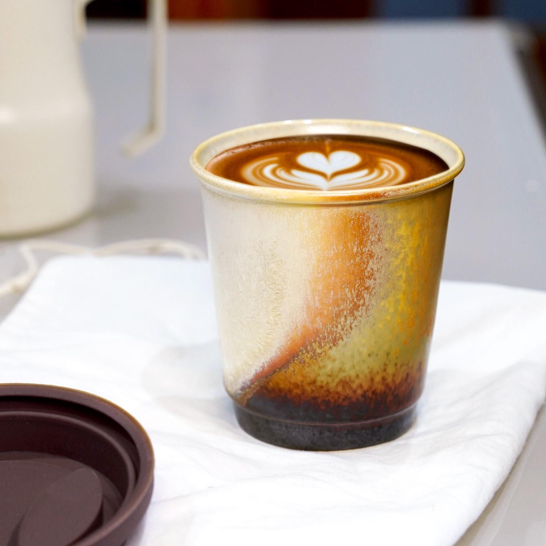 brown reusable mug with white silicone seal - Perfect for hot lattes. Leed-free ceramic, dishwasher safe.